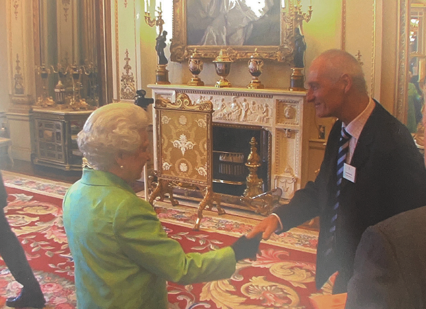 A photograph of Henry shaking hands with Queen Elizabeth 2nd